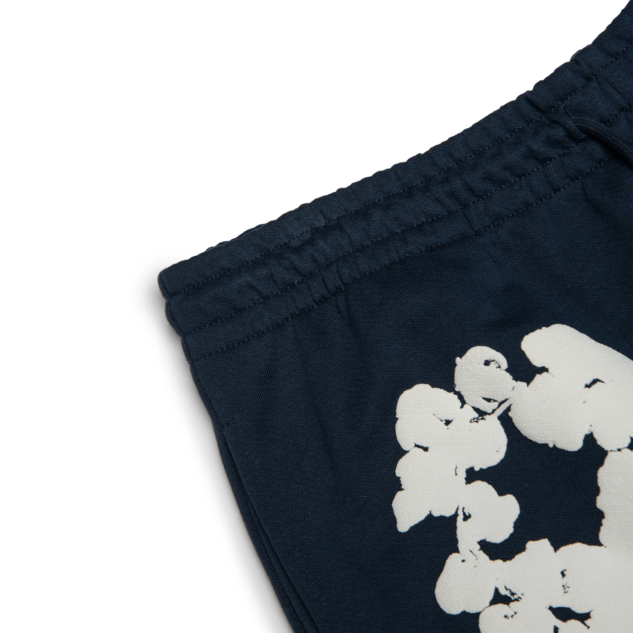 Corner view of Denim Tears The Cotton Wreath Navy Sweatpants